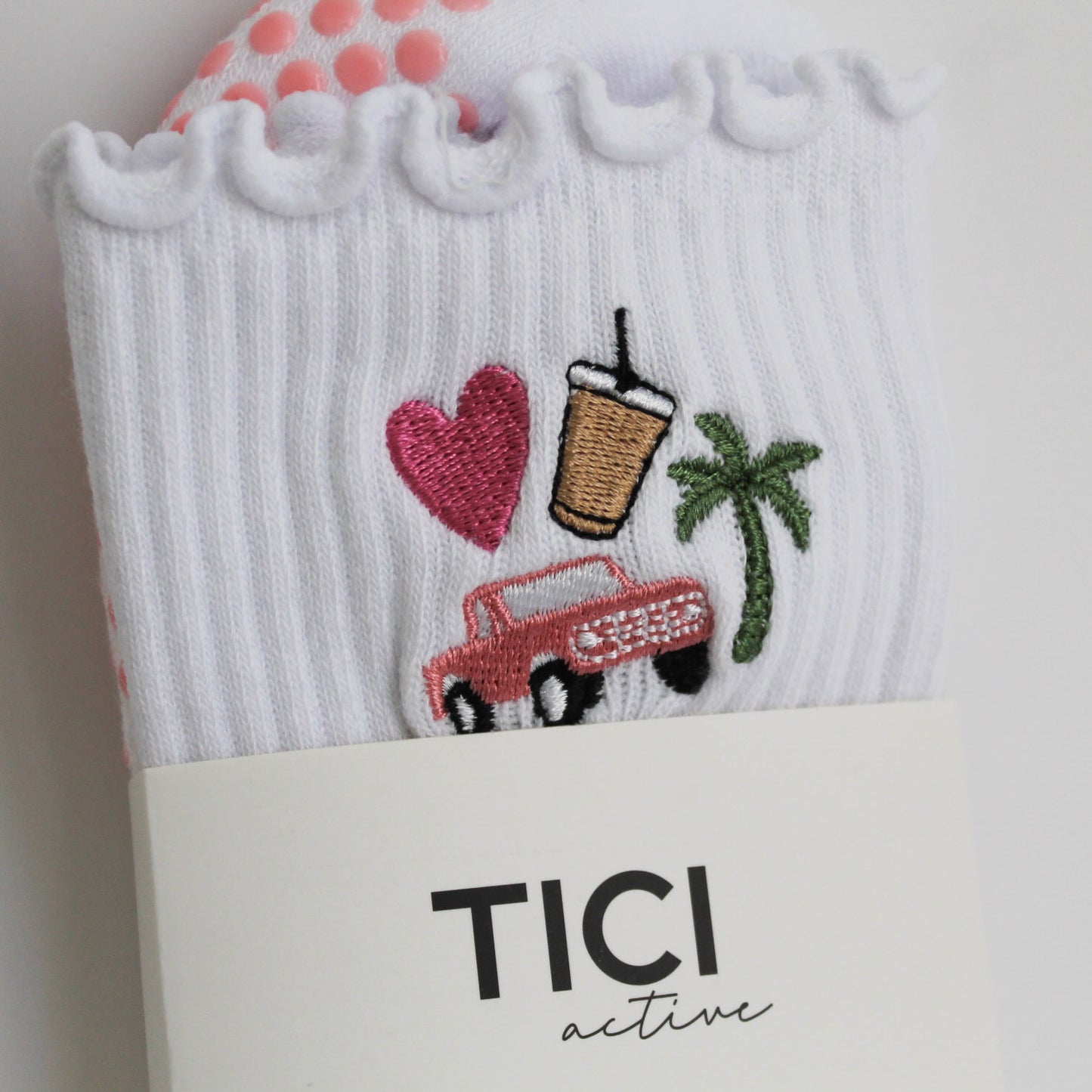 White sock with embroidered designs and 'TICI active' branding on a white background