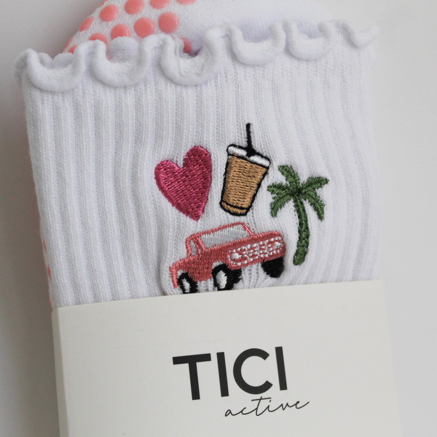 White sock with embroidered designs and 'TICI active' branding on a white background