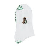 white grip socks with green grips. embroidery of a golden retriever drinking an iced matcha. pilates socks.