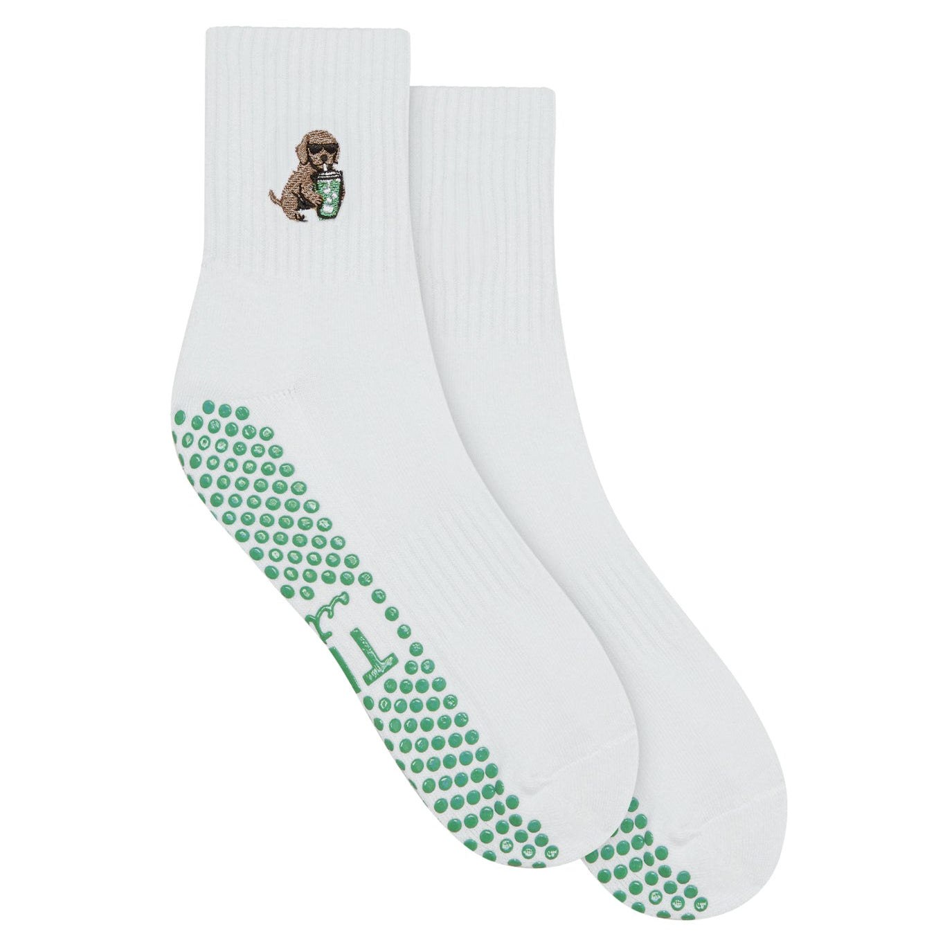 white grip sock by TICI ACTIVE with green grips. Embroidery is a golden retriever dog holding an iced matcha. 
