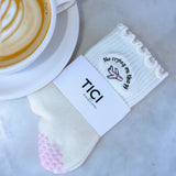 tici active jetsetter grip sock. Cream color sock with light pink grips. Embroidery is a pink private jet,