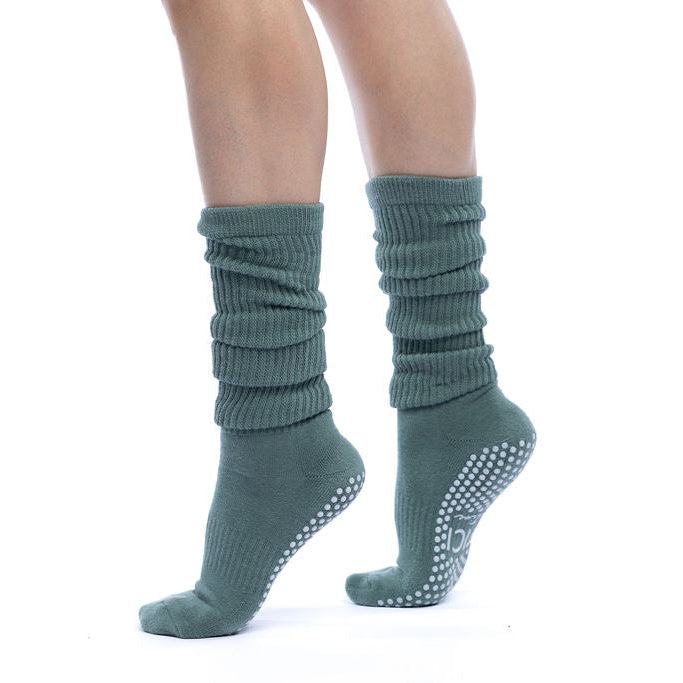 Green scrunch socks with grip sole worn by a person tici active grip socks 
