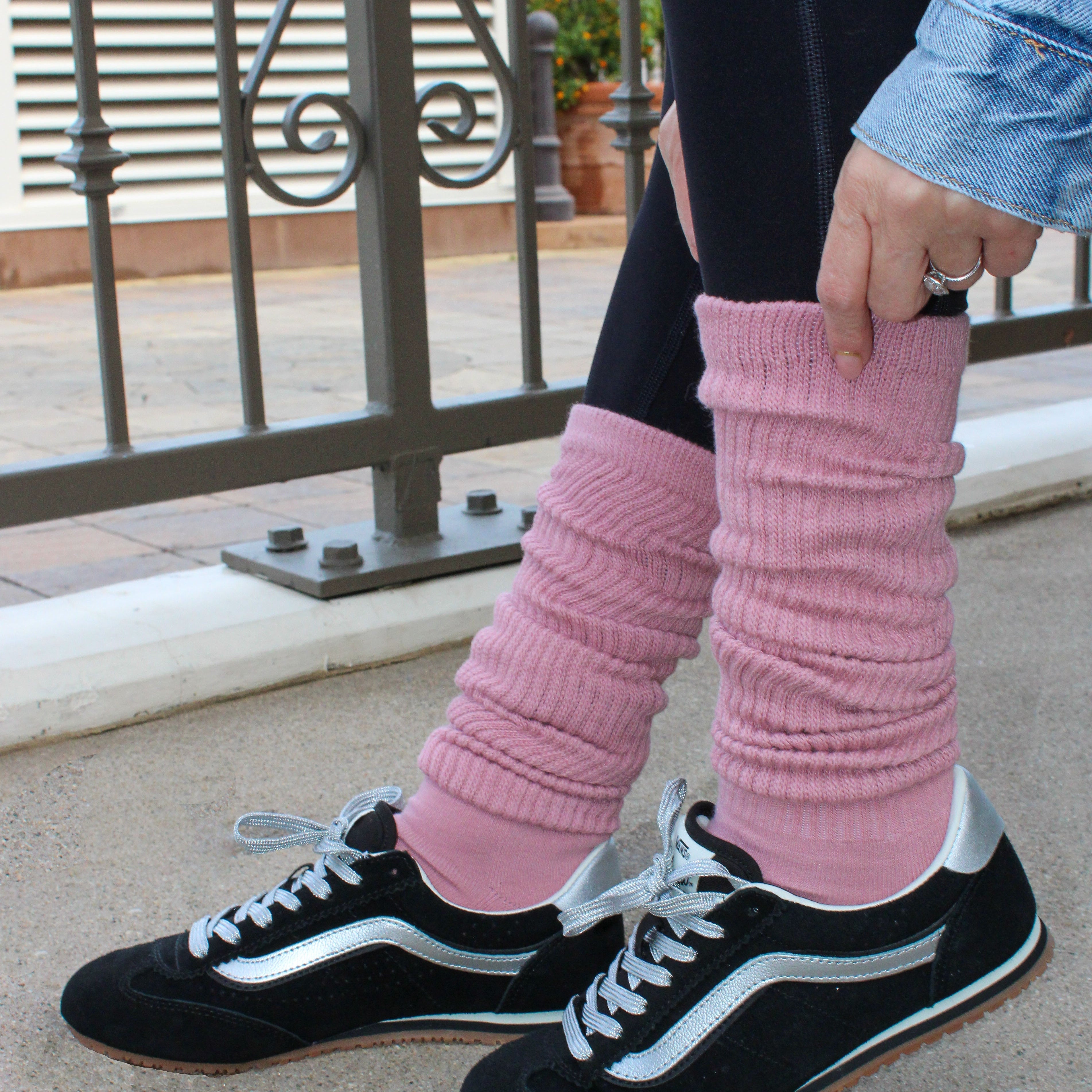 Person wearing black sneakers with white laces and pink knee-high socks. tici active slouchy grip socks at calabasas coffee house. 