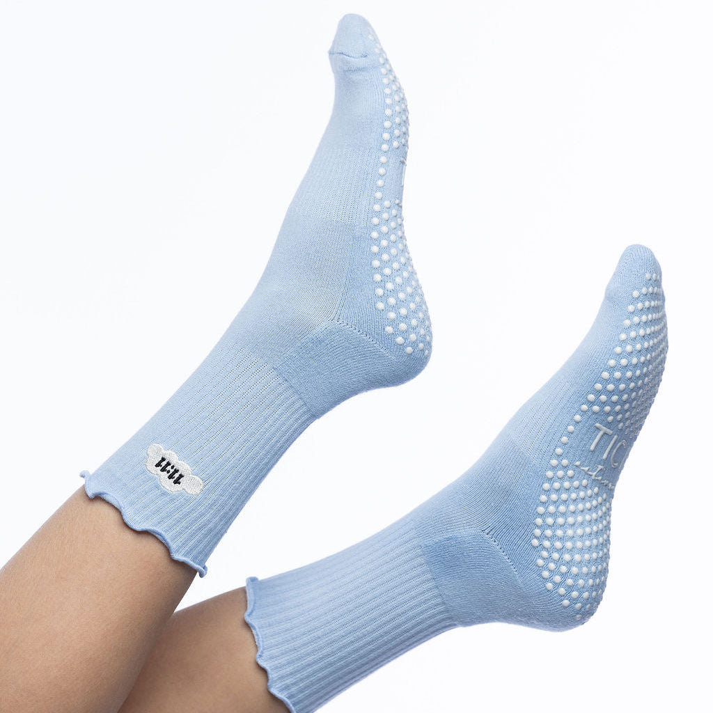 Light blue socks with grip texture on a white background tici active 11:11 1111 grip socks 