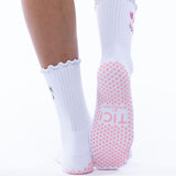 White socks with pink textured grip sole worn by a person  tici active grip socks 