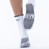 White socks with black grip sole and brand logo on a white background tici active grip socks tici active grip socks 