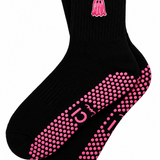 A pair of black ankle socks with pink grip dots on the sole and a pink ghost graphic on the cuff, displayed against a plain white background.