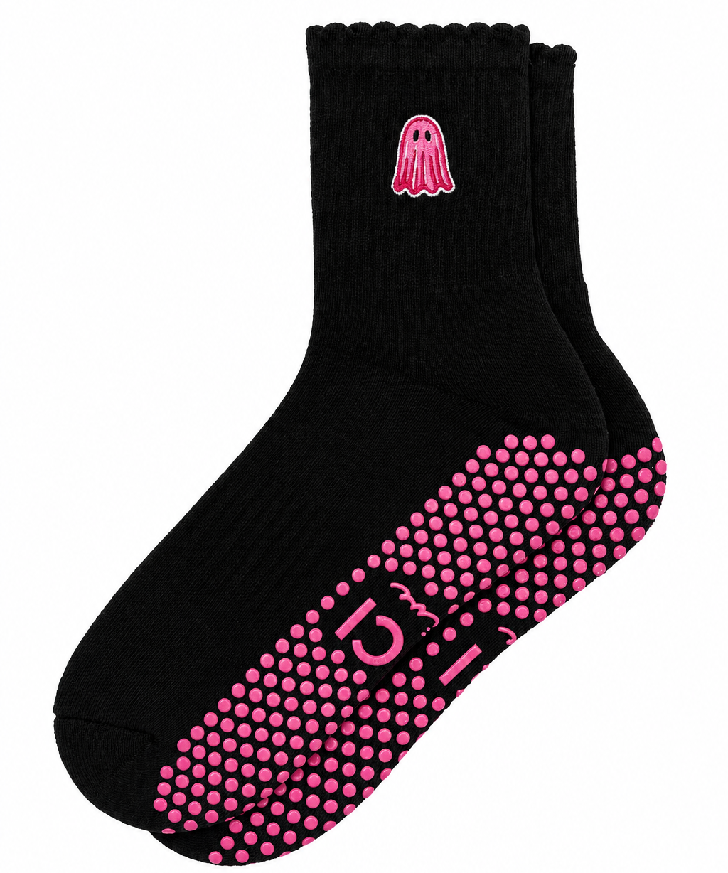 Black grip socks with pink ghost and matching pink grips on a white background. 