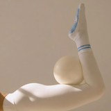 a white pilates grip sock with blue stripes and matching blue grips.
