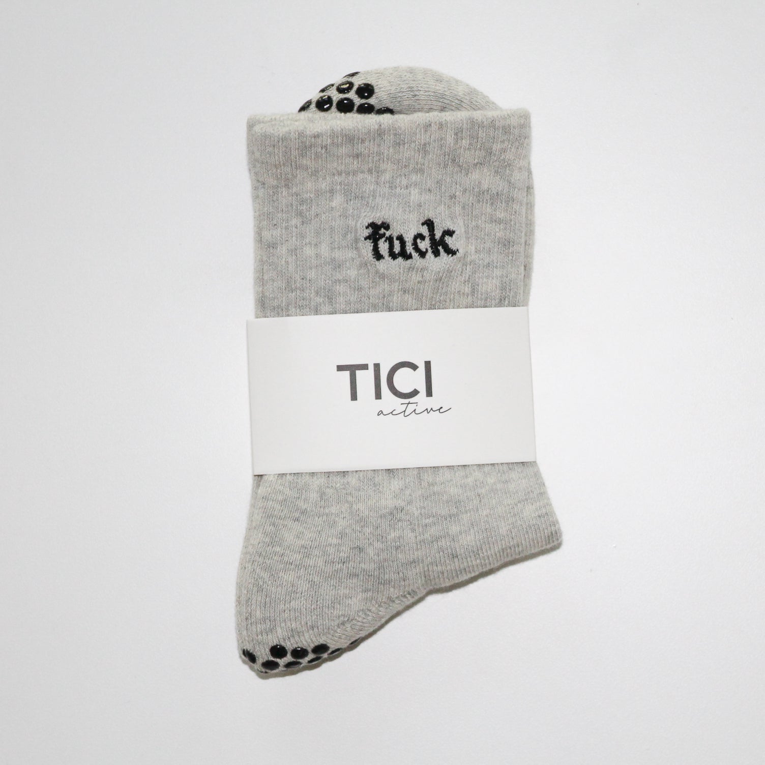 Gray grip socks with black text and 'TICI ACTIVE'  branding on a white background. Grip socks are heather gray with black grips. 