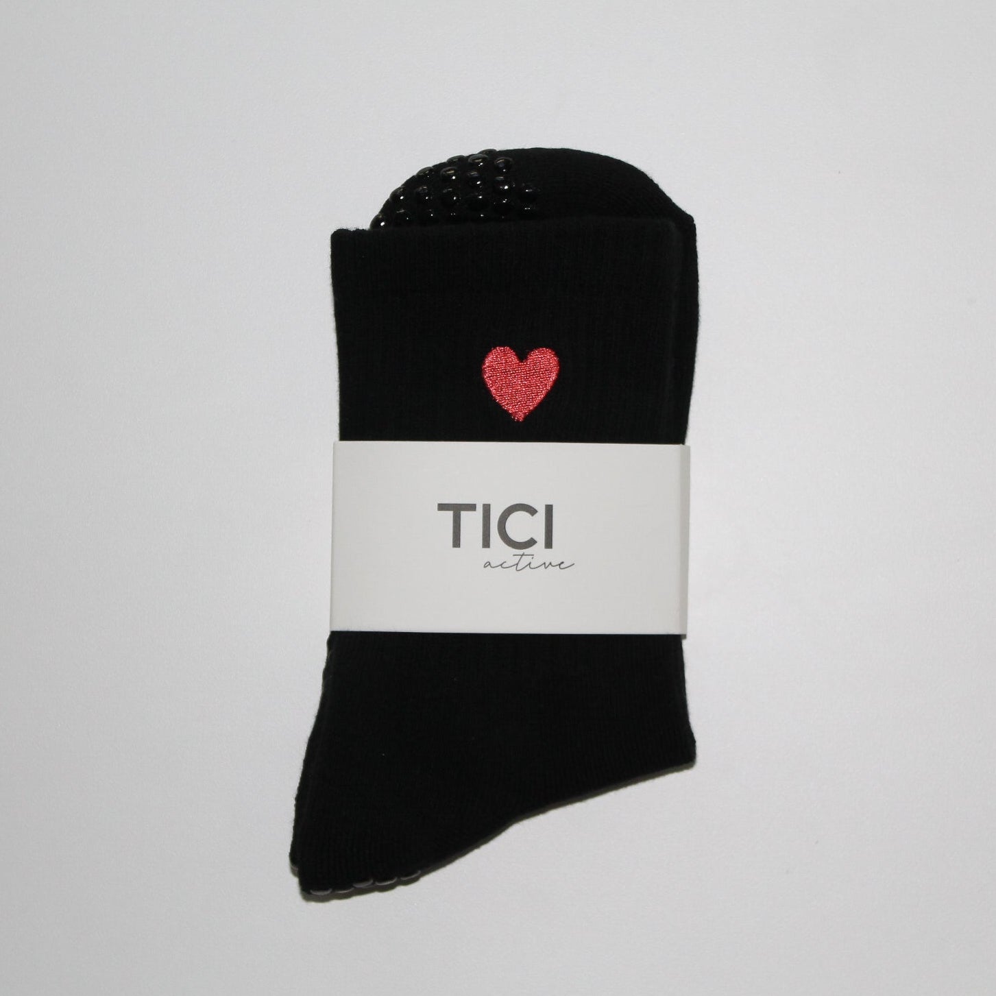 tici active valentines collection grip sock lover grip sock in black with black grips and red heart embroidery.