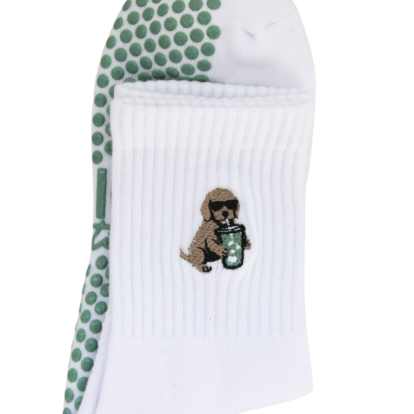 white pilates socks with green rips. a golden retriever drinking an iced matcha. 