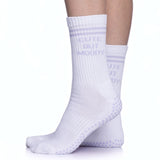 White pilates socks with lavender grips and text that read, "CUTE BUT MOODY"