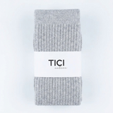A pair of light gray ribbed knit socks folded vertically with a white paper band around the middle that reads 'TICI nature' in black text, set against a plain white background.