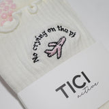 White socks with embroidered design and 'TICI active' label on a white background. pink private jet with text that reads, no crying on the PJ