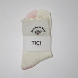 White socks with embroidered design and 'TICI active' label on a white background. pink private jet with text that reads, no crying on the PJ