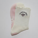 White socks with embroidered design and 'TICI active' label on a white background. pink private jet with text that reads, no crying on the PJ