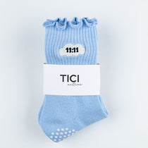 Light blue 11:11 TICI ACTIVE grip sock with ruffles and white grip dots on a white background, featuring the brand 'TICI active'.
