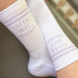 White pilates grip socks with lavender grips.  text that reads, CUTE BUT MOODY.