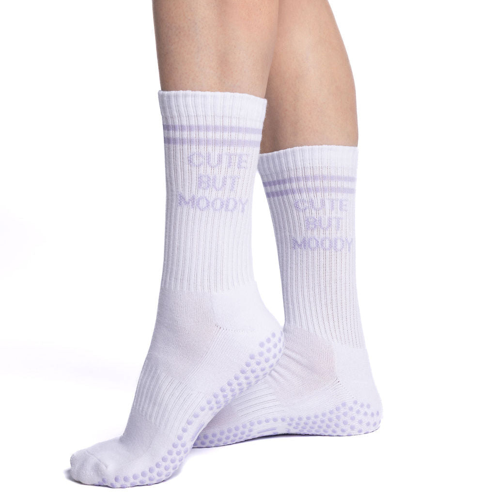 White socks with textured sole worn by a person on a white background, cute but moody