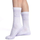 White socks with textured sole worn by a person on a white background, cute but moody