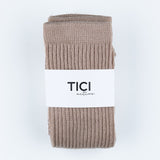 Folded beige sock with 'TICI active' label on a light gray background grip socks CRUNCH SOCKS 
