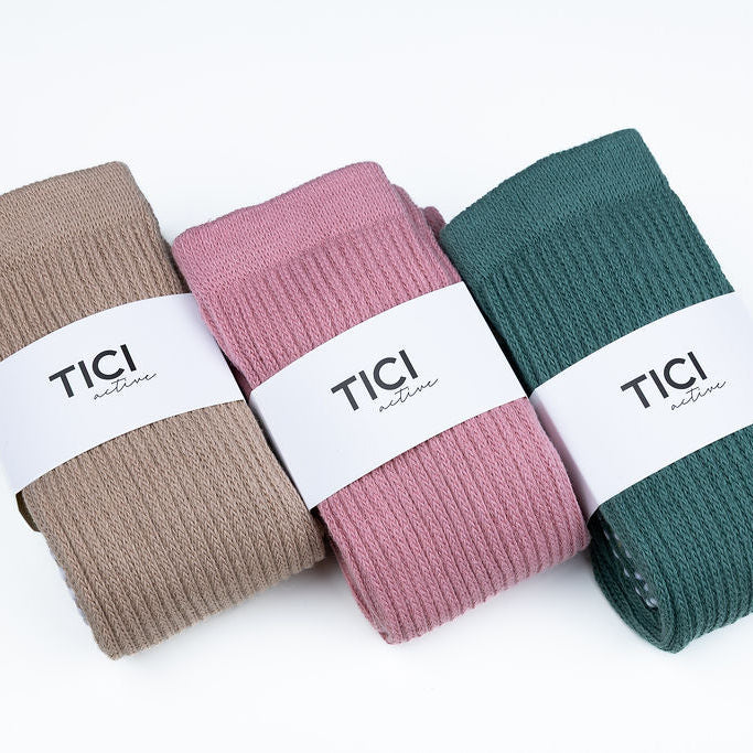 Three pairs of socks in brown, pink, and green with 'TICI' labels on a white background. tici active grip socks scrunch